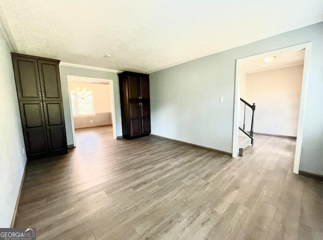 interior space featuring crown molding, a notable chandelier, and light wood-type flooring