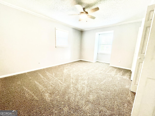 carpeted spare room with ceiling fan, ornamental molding, and a textured ceiling