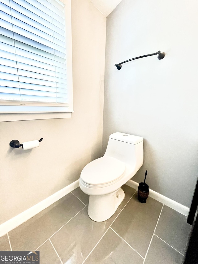 bathroom with tile patterned flooring and toilet