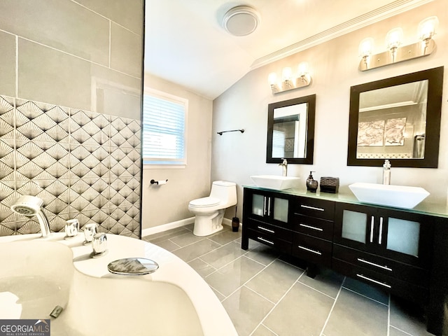 bathroom featuring vaulted ceiling, vanity, crown molding, and toilet