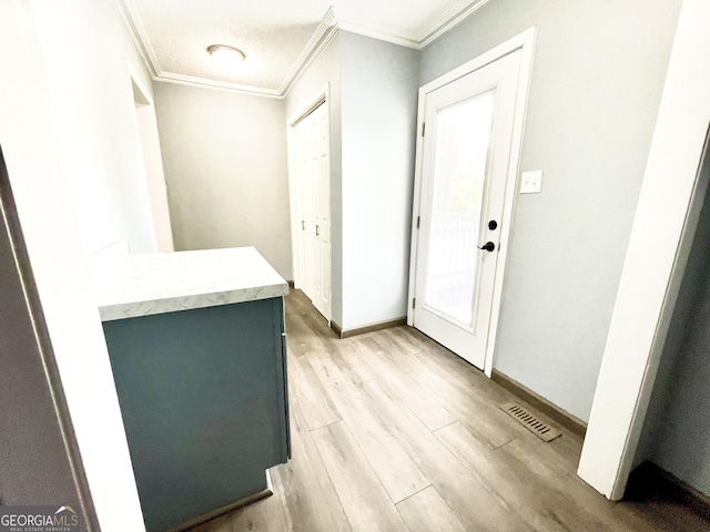 entrance foyer with crown molding and light wood-type flooring