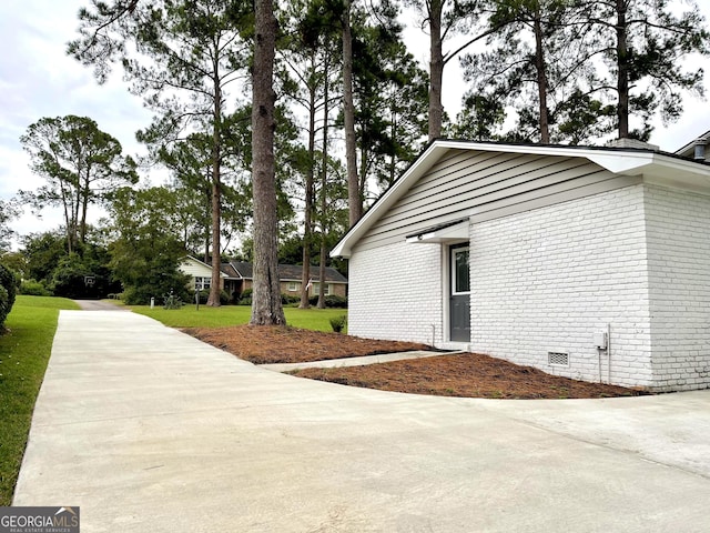 view of property exterior featuring a lawn