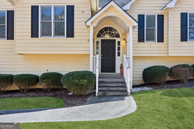 doorway to property featuring a yard