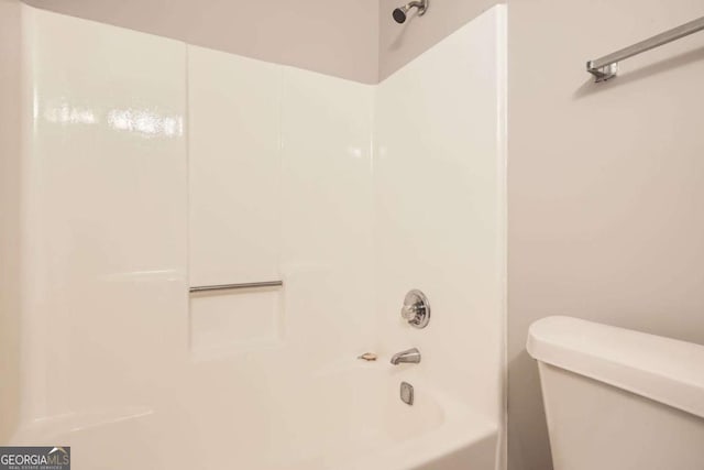 bathroom with shower / washtub combination and toilet