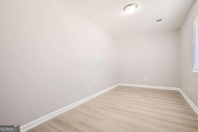 unfurnished room featuring light hardwood / wood-style floors