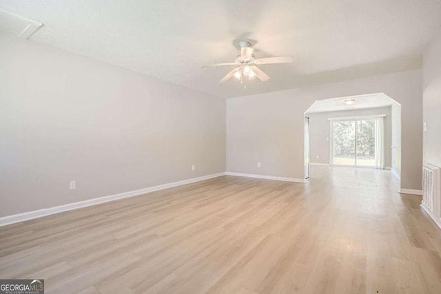 empty room with light hardwood / wood-style flooring and ceiling fan