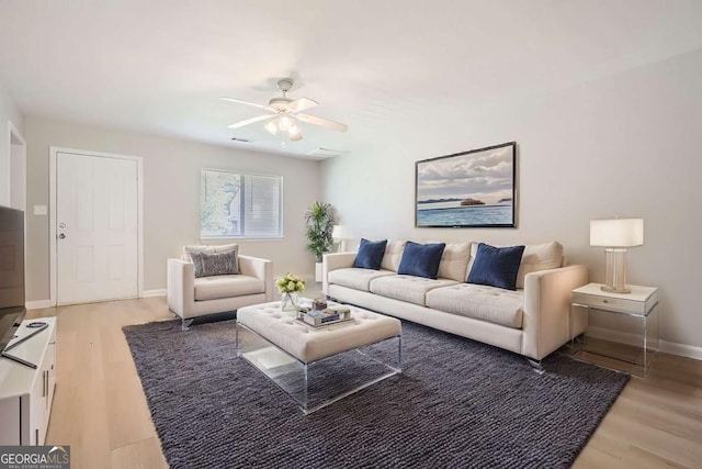 living room with hardwood / wood-style floors and ceiling fan