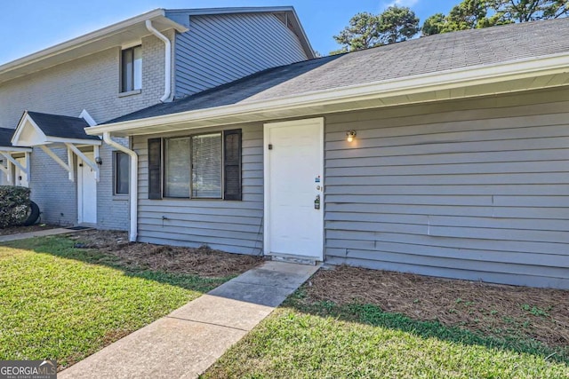 property entrance with a yard