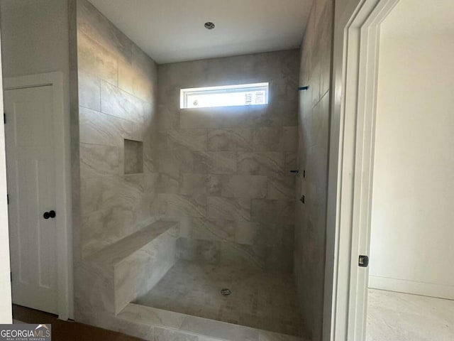 bathroom featuring tiled shower