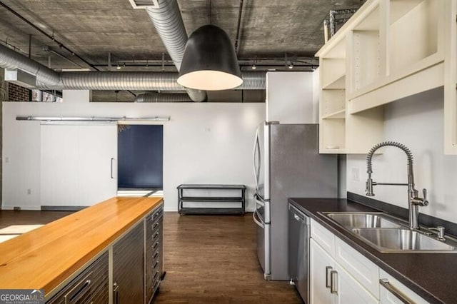 kitchen with white cabinetry, dark hardwood / wood-style flooring, dishwasher, and sink