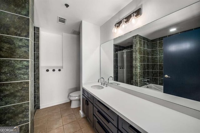 bathroom featuring vanity, toilet, and tile patterned flooring