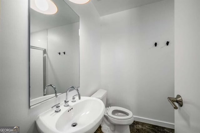 bathroom featuring sink and toilet