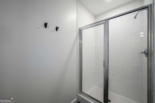 bathroom featuring a shower with shower door