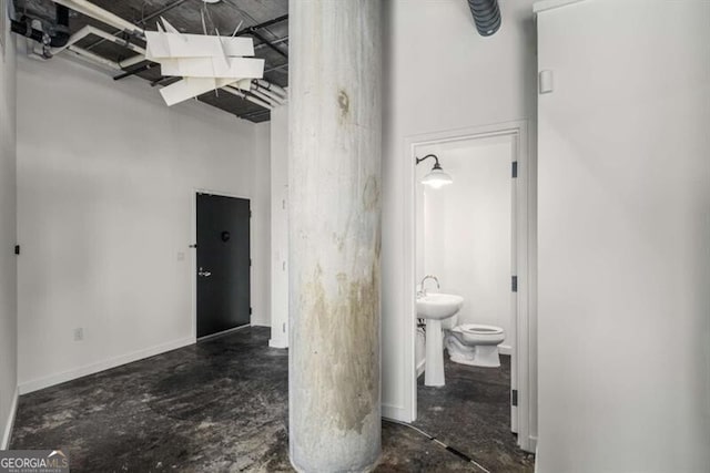 bathroom with toilet and concrete floors