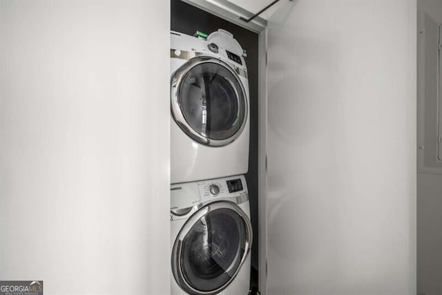 laundry area featuring stacked washer / drying machine