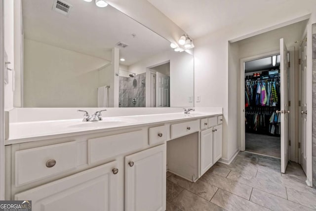 bathroom featuring walk in shower and vanity