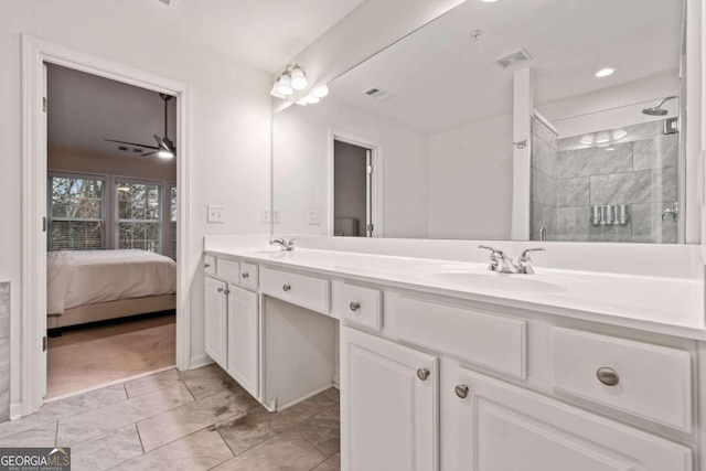 bathroom featuring vanity, a tile shower, and ceiling fan