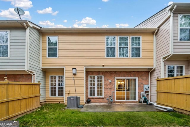 back of property featuring a yard, central AC, and a patio area