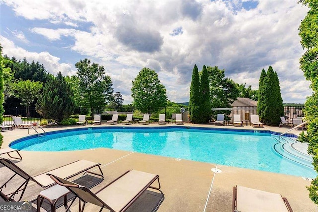 view of swimming pool with a patio