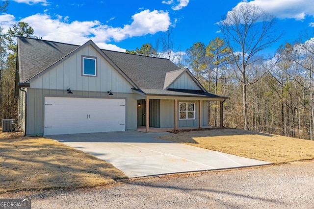 view of front of home featuring a garage and central AC unit