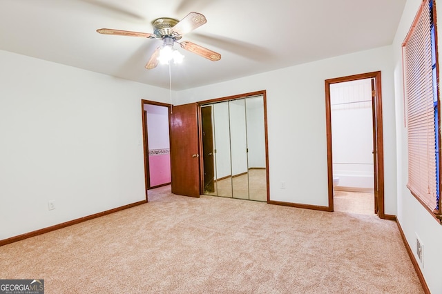 unfurnished bedroom featuring ensuite bathroom, light carpet, and ceiling fan