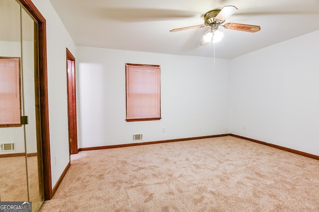 unfurnished bedroom with ceiling fan and light carpet