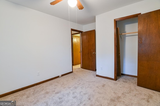 unfurnished bedroom with light carpet, a closet, and ceiling fan