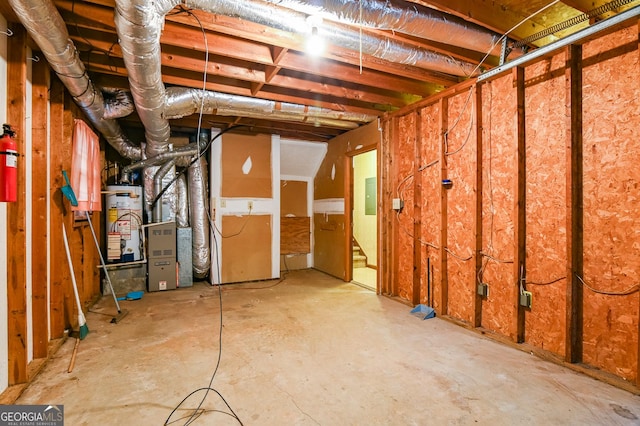 basement featuring water heater and electric panel