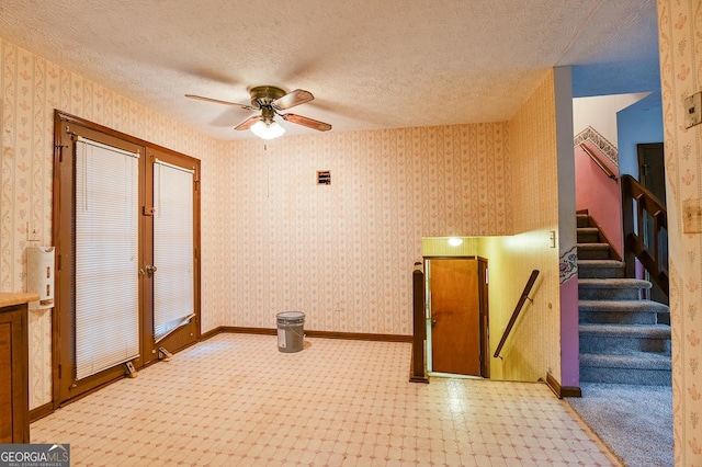 interior space featuring ceiling fan and a textured ceiling