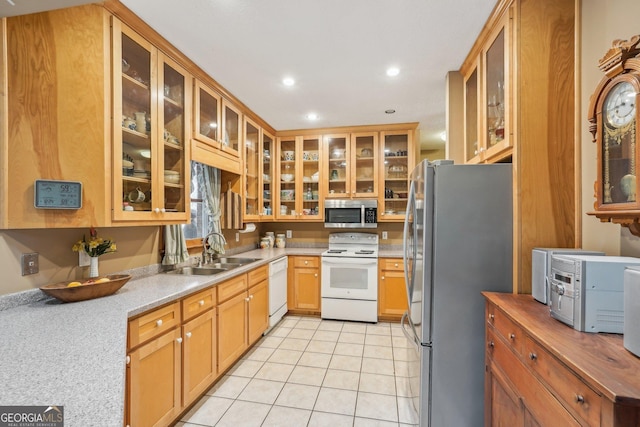 kitchen with stainless steel appliances, sink, and light tile patterned floors