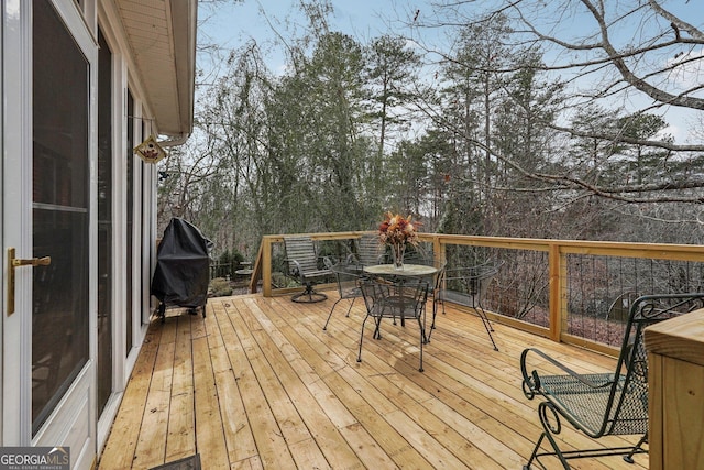 wooden deck featuring outdoor dining area