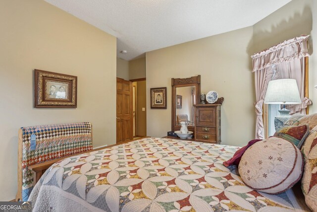 carpeted home office featuring a textured ceiling