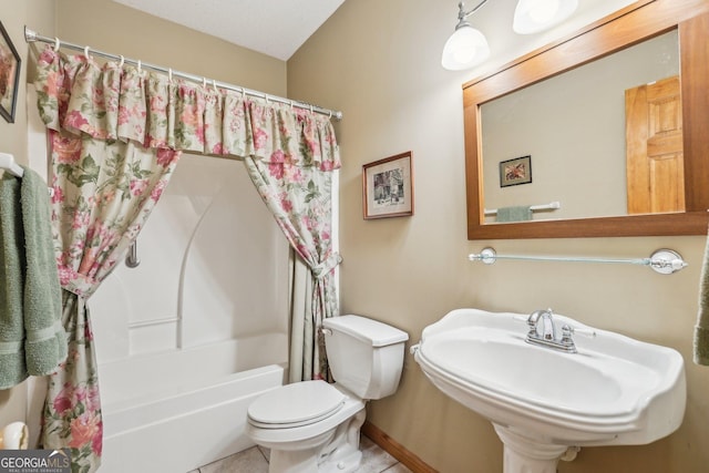 full bathroom featuring toilet, a sink, shower / tub combo with curtain, and tile patterned floors