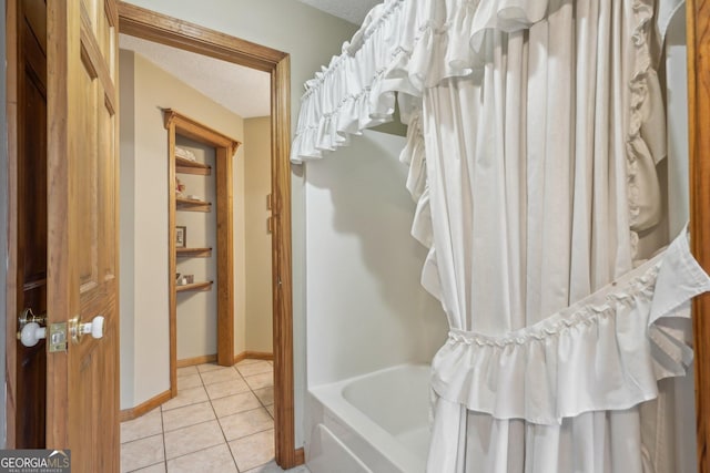 full bath with shower / bath combination with curtain, tile patterned flooring, baseboards, and a textured ceiling