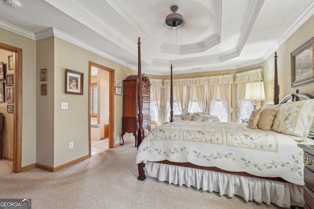 carpeted bedroom featuring ornamental molding, a raised ceiling, a textured ceiling, and baseboards