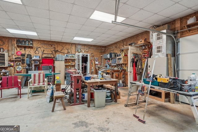 garage with wooden walls and a workshop area