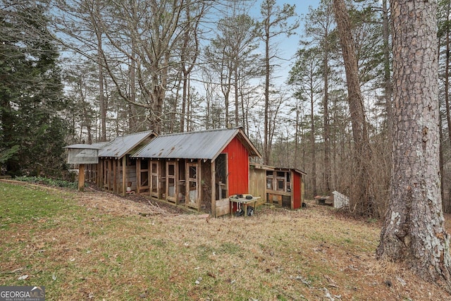 view of outdoor structure featuring a lawn