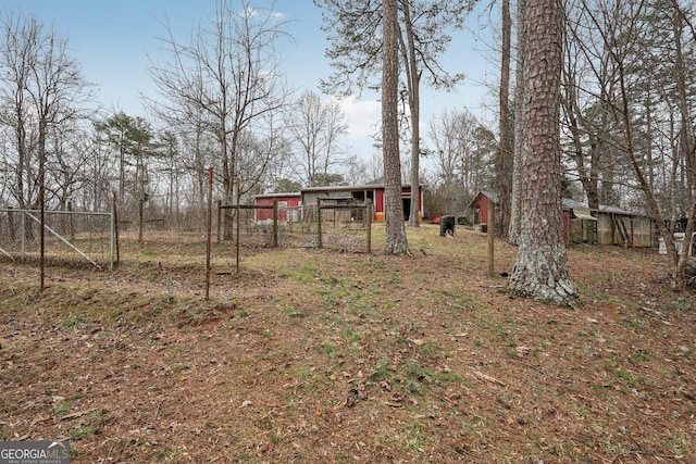 view of yard featuring fence and an outdoor structure