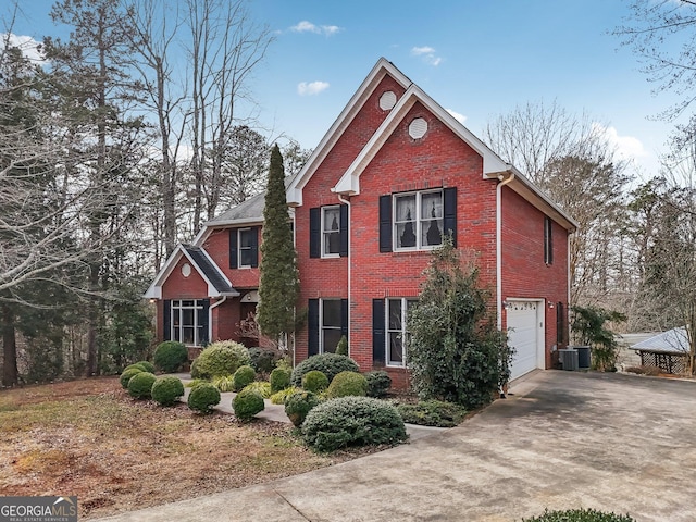 traditional-style house with a garage, concrete driveway, brick siding, and a chimney