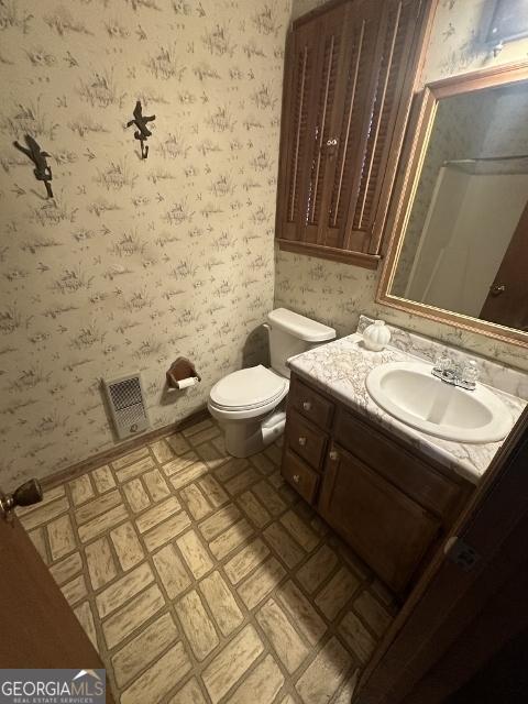 bathroom with vanity and toilet