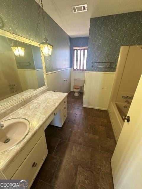 full bathroom featuring vanity, plus walk in shower, and toilet