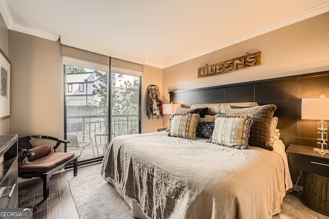 bedroom featuring crown molding, a wall of windows, access to exterior, and hardwood / wood-style flooring