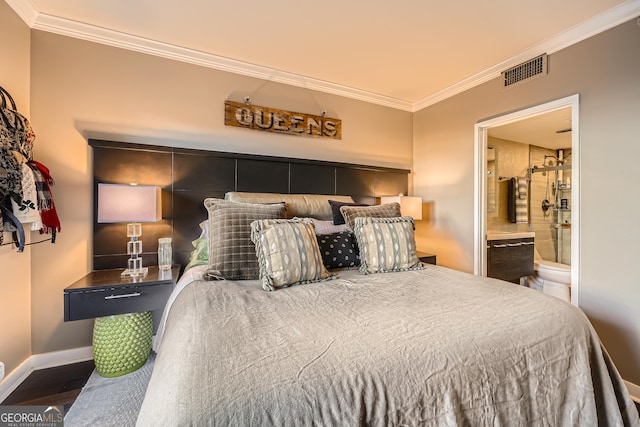 bedroom with crown molding, connected bathroom, and dark hardwood / wood-style floors