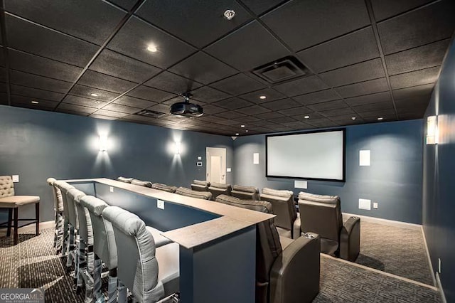 carpeted home theater with a paneled ceiling