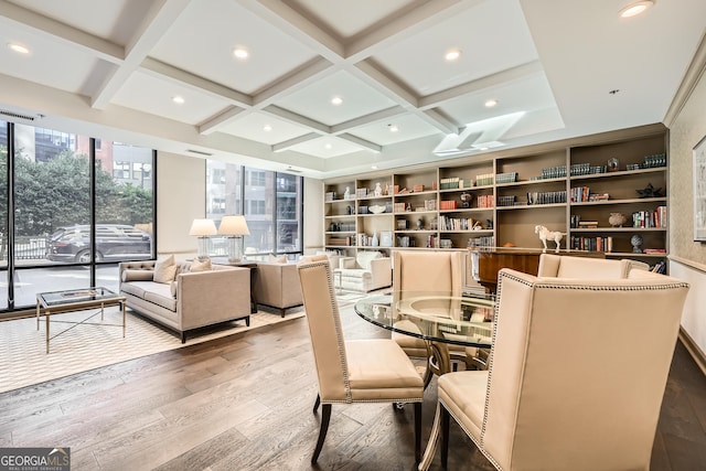 dining space featuring beamed ceiling, coffered ceiling, and hardwood / wood-style floors