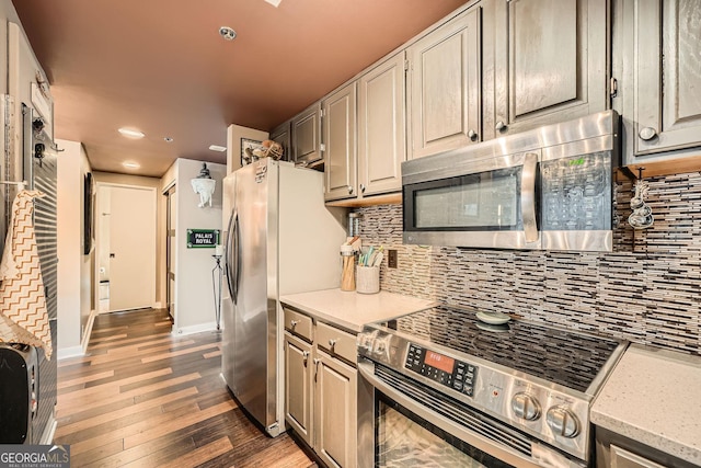 kitchen featuring tasteful backsplash, stainless steel appliances, and dark hardwood / wood-style flooring