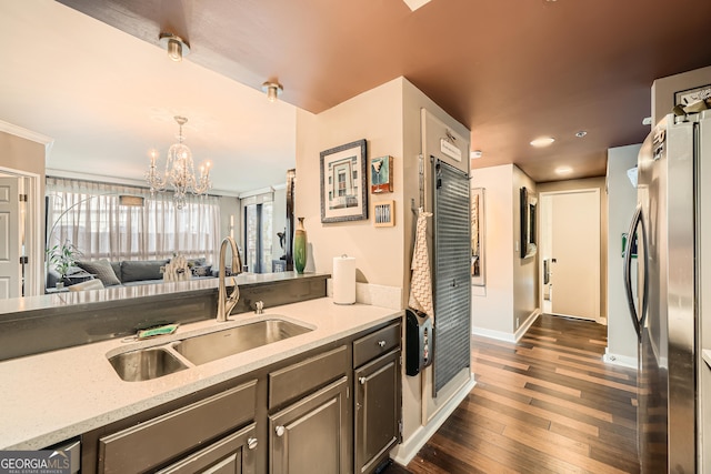 kitchen featuring sink, stainless steel fridge, an inviting chandelier, dark hardwood / wood-style floors, and decorative light fixtures