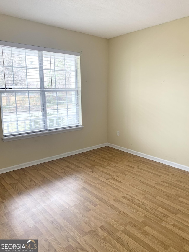 spare room featuring light wood-type flooring