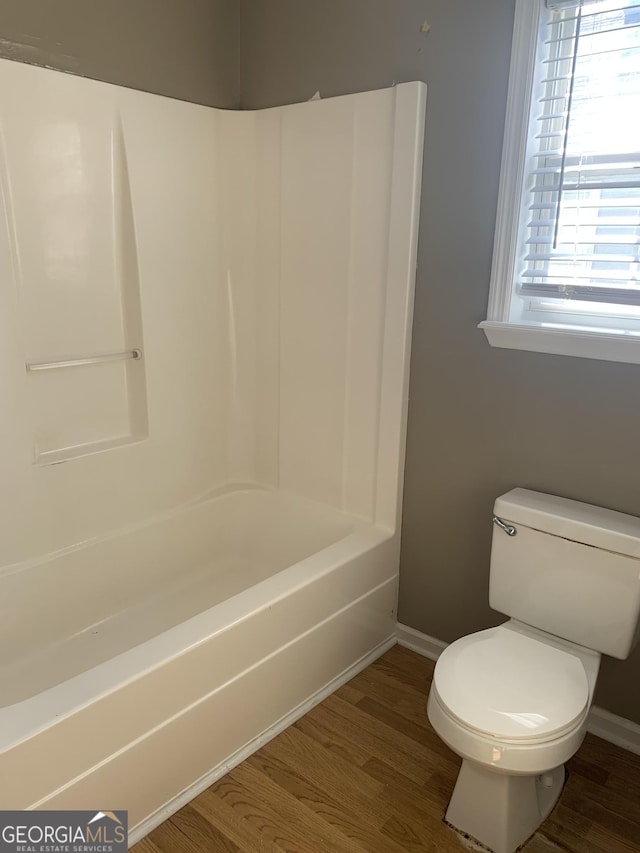 bathroom featuring wood finished floors, toilet, and baseboards