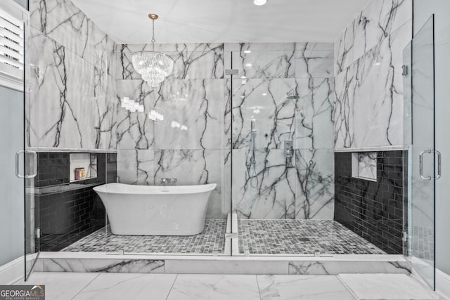 bathroom featuring a notable chandelier, a fireplace, and separate shower and tub